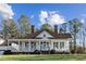Classic home with a cozy front porch, painted in white, under a clear blue sky at 1325 Whitlock Sw Ave, Marietta, GA 30064