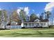 Charming white home with a welcoming porch and manicured lawn against a blue sky backdrop at 1325 Whitlock Sw Ave, Marietta, GA 30064