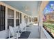 Relaxing front porch with rocking chairs, ceiling fan, and view of the green lawn at 1325 Whitlock Sw Ave, Marietta, GA 30064