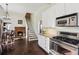 Charming kitchen with stainless steel appliances, light cabinets and staircase to the upper level at 1325 Whitlock Sw Ave, Marietta, GA 30064