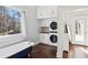 Well-lit laundry room featuring a claw foot tub and stacked washer and dryer at 1325 Whitlock Sw Ave, Marietta, GA 30064
