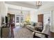 Bright living room with hardwood floors, neutral decor, exposed beams, and french doors to the exterior at 1325 Whitlock Sw Ave, Marietta, GA 30064