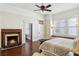 Bright main bedroom with a fireplace, windows with a bench, and hardwood floors at 1325 Whitlock Sw Ave, Marietta, GA 30064