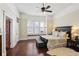 Spacious main bedroom with dark furniture, hardwood floors, and an abundance of natural light at 1325 Whitlock Sw Ave, Marietta, GA 30064