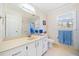Bathroom featuring a vanity, mirror, window, and neutral decor at 1532 Boxwood Nw Trce, Acworth, GA 30102