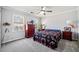 Bedroom featuring two windows, carpet flooring, and a large dresser at 1532 Boxwood Nw Trce, Acworth, GA 30102