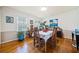 Bright dining room featuring hardwood floors, decorative plants, and a charming table setting, perfect for gatherings at 1532 Boxwood Nw Trce, Acworth, GA 30102