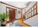 Bright foyer features hardwood floors, a wooden staircase, and a decorative rug, creating an inviting entrance at 1532 Boxwood Nw Trce, Acworth, GA 30102