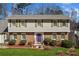 Beautiful home boasts a well-manicured lawn, attractive landscaping, and a welcoming purple front door at 1532 Boxwood Nw Trce, Acworth, GA 30102