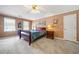 Main bedroom features a bed, windows for natural light, and a ceiling fan at 1532 Boxwood Nw Trce, Acworth, GA 30102