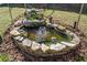 Charming backyard pond featuring a waterfall, stone border, and aquatic plants, creating a serene retreat at 1532 Boxwood Nw Trce, Acworth, GA 30102