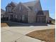 Two car garage with a concrete drive and beautiful brick and siding at 3671 Casual Ridge Way, Loganville, GA 30052