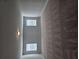 Bright hallway with two windows and neutral carpet, providing a transition between living spaces at 3671 Casual Ridge Way, Loganville, GA 30052
