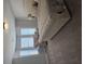 Bright main bedroom features neutral colors, a plush bed, and a sitting area bathed in natural light from multiple windows at 3671 Casual Ridge Way, Loganville, GA 30052