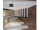 Stylish staircase with dark wood steps, white risers, and wrought iron railing, with foyer decor at 3671 Casual Ridge Way, Loganville, GA 30052