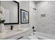 Chic bathroom with marble-style tile, black fixtures, and separate tub and shower at 7608 Parkland Bnd, Fairburn, GA 30213