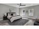 This bedroom has gray wood flooring, recessed lighting, and two windows at 7608 Parkland Bnd, Fairburn, GA 30213