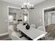 Chic dining room featuring stylish furniture with a view to the fireplace and living room at 7608 Parkland Bnd, Fairburn, GA 30213