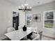 Elegant dining room with modern chandelier, table and view to the kitchen at 7608 Parkland Bnd, Fairburn, GA 30213