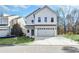 Charming two-story home with a two-car garage and well-maintained lawn at 7608 Parkland Bnd, Fairburn, GA 30213