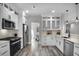 Well-equipped kitchen featuring white cabinets, modern appliances, and stylish finishes at 7608 Parkland Bnd, Fairburn, GA 30213