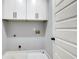 Laundry room with white cabinets at 7608 Parkland Bnd, Fairburn, GA 30213