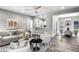 Bright living room with stylish furniture, a ceiling fan, and an open floor plan at 7608 Parkland Bnd, Fairburn, GA 30213