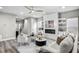Cozy living room featuring a fireplace, built-in shelves, and modern decor at 7608 Parkland Bnd, Fairburn, GA 30213
