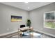 Home office with ample natural light, desk, and decor at 7608 Parkland Bnd, Fairburn, GA 30213