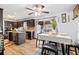 Eat-in kitchen and dining area features stainless appliances, wood floors, and sliding door to backyard at 916 Marshall Fuller Rd, Dallas, GA 30157