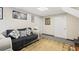 Cozy basement living room area with couch, lamp, and framed art at 916 Marshall Fuller Rd, Dallas, GA 30157
