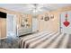 Bright bedroom with queen bed, ceiling fan, and neutral colored walls and flooring at 916 Marshall Fuller Rd, Dallas, GA 30157
