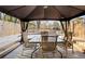 Relaxing covered patio area featuring seating and a wooden deck at 916 Marshall Fuller Rd, Dallas, GA 30157