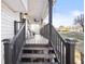 Covered front porch with wooden railings and steps leading up to the entrance at 916 Marshall Fuller Rd, Dallas, GA 30157