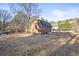 Large wooden shed for storage and outdoor equipment in a wooded area at 916 Marshall Fuller Rd, Dallas, GA 30157