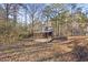 Outdoor wooden shed with a metal roof, set among trees and foliage at 916 Marshall Fuller Rd, Dallas, GA 30157