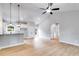 Spacious living room area flowing into the kitchen with white cabinets and stainless steel appliances at 1765 Harmony Rd, Temple, GA 30179