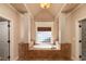 Soaking tub with a window view framed by columns in a naturally lit primary bathroom at 1837 Haven Park Se Cir, Smyrna, GA 30080