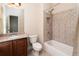 Bathroom with granite-topped vanity, toilet, and a tiled bathtub-shower combination at 1837 Haven Park Se Cir, Smyrna, GA 30080