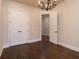 Spacious bedroom with hardwood floors and elegant chandelier offers generous closet space and easy access to other rooms at 1837 Haven Park Se Cir, Smyrna, GA 30080
