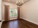 Bedroom with hardwood floors, natural light from the window, and stylish chandelier creates an inviting atmosphere at 1837 Haven Park Se Cir, Smyrna, GA 30080