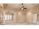 Large bedroom with tray ceilings, ceiling fan, neutral paint and carpet, and access to a private outdoor deck at 1837 Haven Park Se Cir, Smyrna, GA 30080