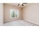 Neutral bedroom with a ceiling fan, carpet, and a window overlooking the trees at 1837 Haven Park Se Cir, Smyrna, GA 30080