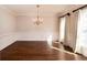 Open and airy dining room with gleaming hardwood floors, classic wainscoting, and natural light at 1837 Haven Park Se Cir, Smyrna, GA 30080