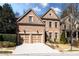 Charming brick home featuring a two-car garage, manicured lawn, and classic architectural details at 1837 Haven Park Se Cir, Smyrna, GA 30080
