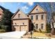 Charming brick home featuring a two-car garage, manicured lawn, and classic architectural details at 1837 Haven Park Se Cir, Smyrna, GA 30080