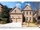 Charming brick home featuring a two-car garage, manicured lawn, and classic architectural details at 1837 Haven Park Se Cir, Smyrna, GA 30080