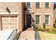 Close-up of the front door of a brick home with a landscaped entryway and a two-car garage at 1837 Haven Park Se Cir, Smyrna, GA 30080
