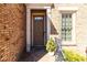 Close-up of a front door entrance with brick columns, metal railing and a neatly trimmed shrub at 1837 Haven Park Se Cir, Smyrna, GA 30080