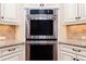 Close-up of stainless steel double ovens and granite countertops at 1837 Haven Park Se Cir, Smyrna, GA 30080